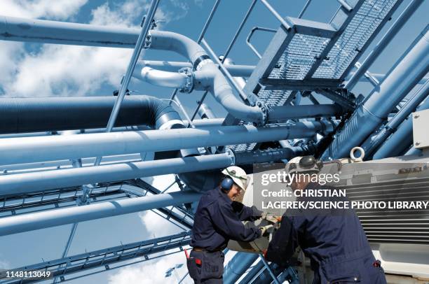 refinery workers - oil and gas workers stock-fotos und bilder