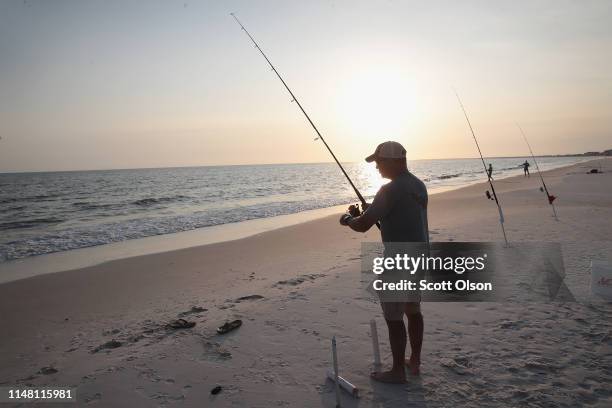 Scott Bodiford fishes on the beach after spending the day restoring homes that were damaged by Hurricane Michael on May 09, 2019 in Mexico Beach,...