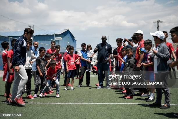 French former football star and Barca foundation ambassador, Lilian Thuram , stands amid young refugees at the Skaramangas camp, on the outskirts of...