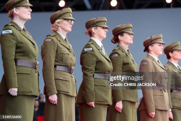 Performers dressed as female soldiers take part in an event to commemorate the 75th anniversary of the D-Day landings, in Portsmouth, southern...