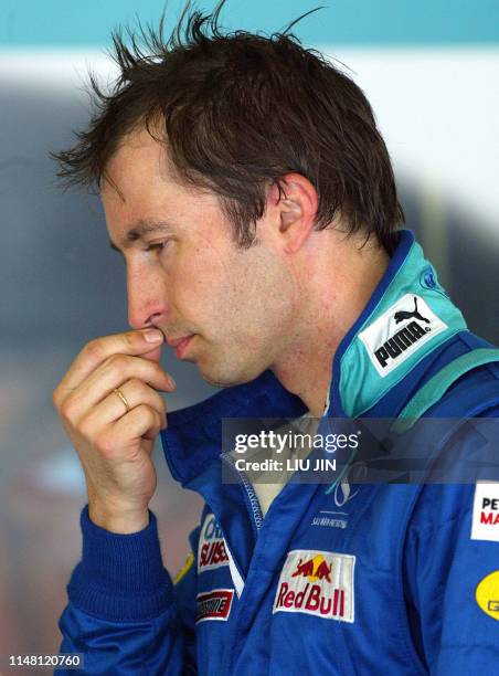 Petronas driver Heinz Harald Frentzen of Germany walks following the second timed session of the Malaysian Grand Prix in Sepang, 22 March 2003. Heinz...