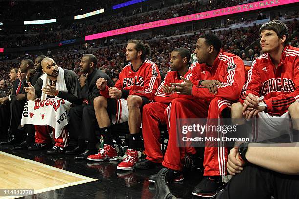 Chicago Bulls players look on from the bench including Carlos Boozer, Joakim Noah and Kyle Korver late in the fourth quarter against the Miami Heat...