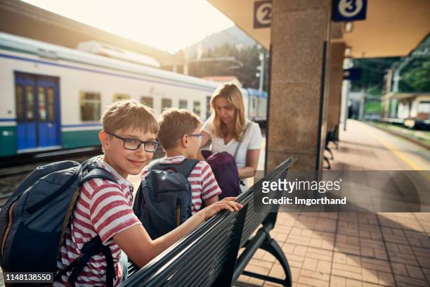 family waiting for train at italian train station - waiting for train stock pictures, royalty-free photos & images