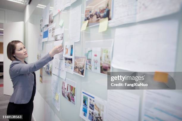 woman touching idea document on bulletin board - notice board stock pictures, royalty-free photos & images