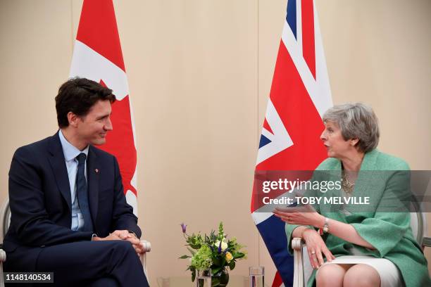 Britain's Prime Minister Theresa May talks with Canadian Prime Minister Justin Trudeau during their bilateral meeting on the sidelines of an event to...