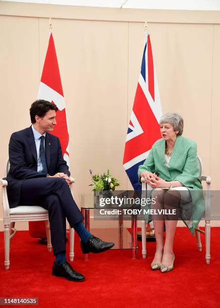 Britain's Prime Minister Theresa May talks with Canadian Prime Minister Justin Trudeau during their bilateral meeting on the sidelines of an event to...