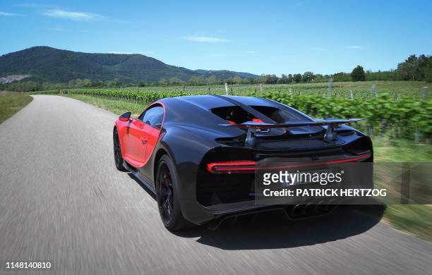 Driver steers a Bugatti Chiron near the luxury automobiles manufacturer Bugatti's headquarters in Molsheim, eastern France, on June 5, 2019.