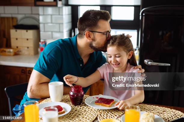 father and daughter having breakfast at home - breakfast fathers imagens e fotografias de stock