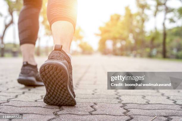 runner feet running on road closeup on shoe. - marathon feet stock pictures, royalty-free photos & images