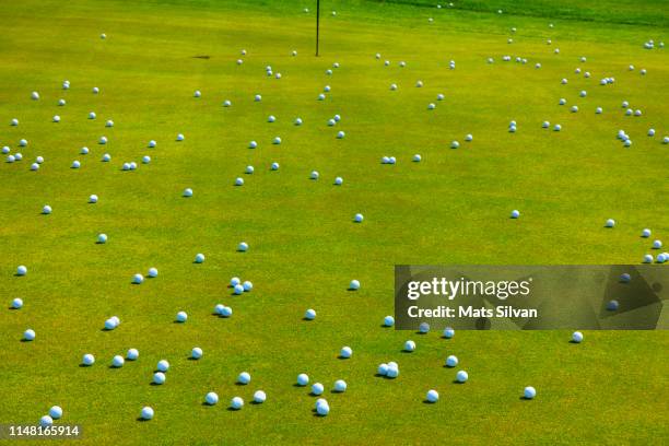 golf putting green with many golf balls - golfgreen stock pictures, royalty-free photos & images