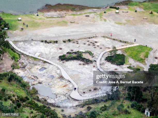 volcanic fumaroles with holes between the rocks issuing gases and very hot boiling water. island of sao miguel, azores islands, portugal. - furnas valley stock pictures, royalty-free photos & images