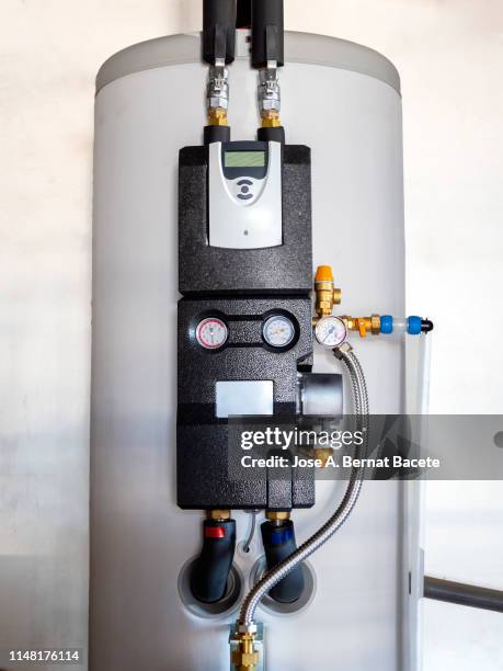 hot water tank inside a house connected to solar panels. solar water heater. - chaudière photos et images de collection