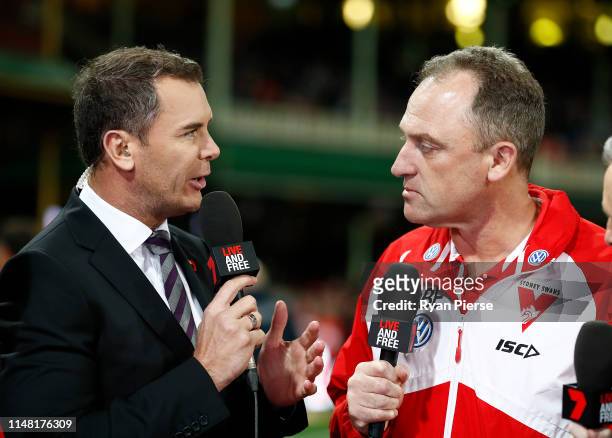 Former AFL player Wayne Carey interviews John Longmire, coach of the Swans, looks on during the round eight AFL match between the Sydney Swans and...
