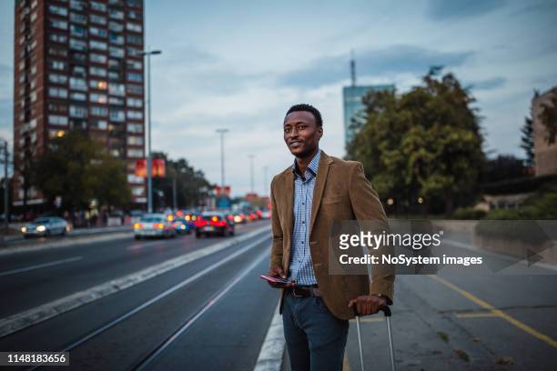 African-American businessman on a business trip using mobile phone