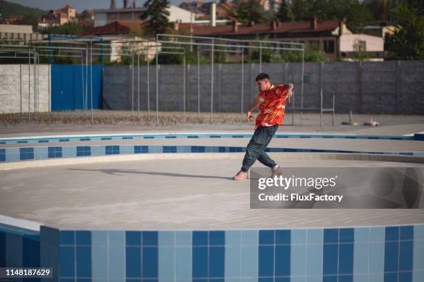 passionate dancer enjoying his alone time dancing at a poolside on a summer day - only young men stock pictures, royalty-free photos & images