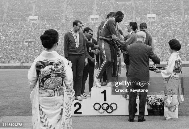 Ulis Williams, Henry Carr, Mike Larrabee and Ollan Cassell of the United States receive their gold medals at the medal ceremony for winning the Men's...