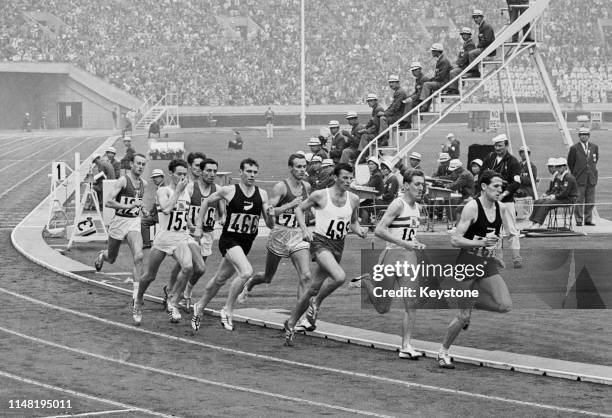 Timing judges watch as Alan Simpson , Dyrol Burleson , Witold Baran , John Whetton , John Davies and eventual winner Peter Snell of New Zealand...