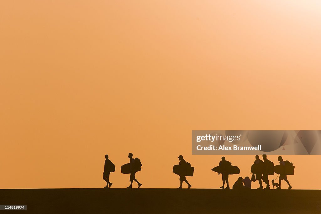 Surfers at sunset