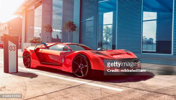 electric sports car gets power for batteries through charging station - red car wire stock pictures, royalty-free photos & images