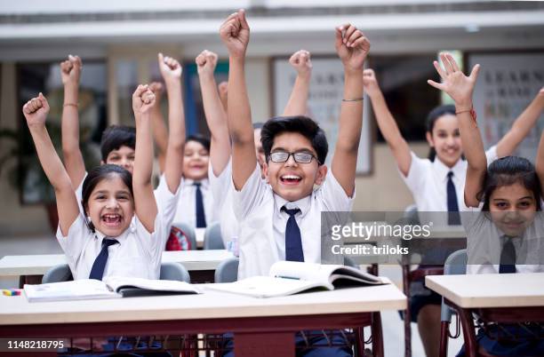 children cheering in classroom - india stock pictures, royalty-free photos & images