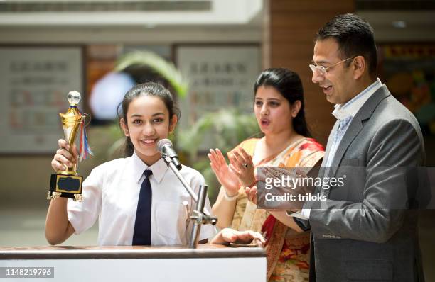 teachers applauding for student at awards ceremony - winning stock pictures, royalty-free photos & images