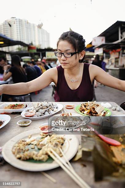 woman with table of street food, penang - penang ストックフォトと画像