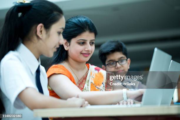 teacher holding digital tablet in classroom - school india stock pictures, royalty-free photos & images