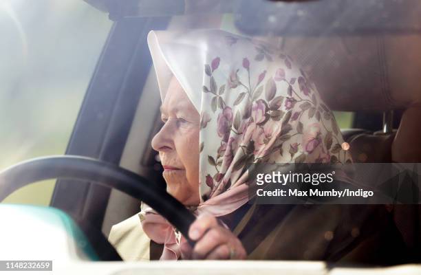 Queen Elizabeth II drives herself in her Range Rover car as she attends day 3 of the Royal Windsor Horse Show in Home Park on May 10, 2019 in...