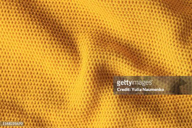 texture of knitted fabric of yellow color. bright yellow abstract background. fabric mustard color. - clothing texture stock pictures, royalty-free photos & images