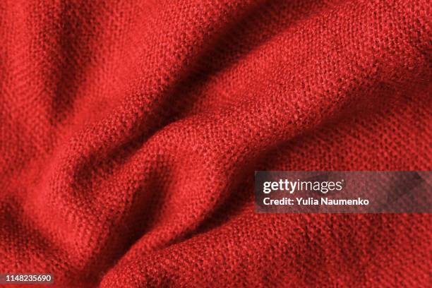 texture of knitted read fabric. light read thick winter fabric. - wool textures stockfoto's en -beelden