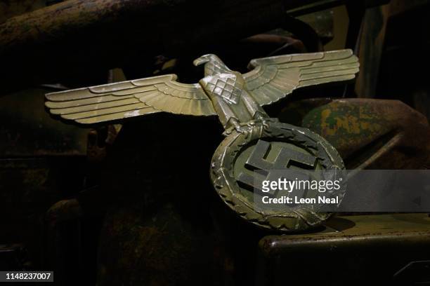 German eagle with swastika emblem is seen inside a display case at the D-Day Experience museum on May 07, 2019 in Saint-Côme-du-Mont, France. The...