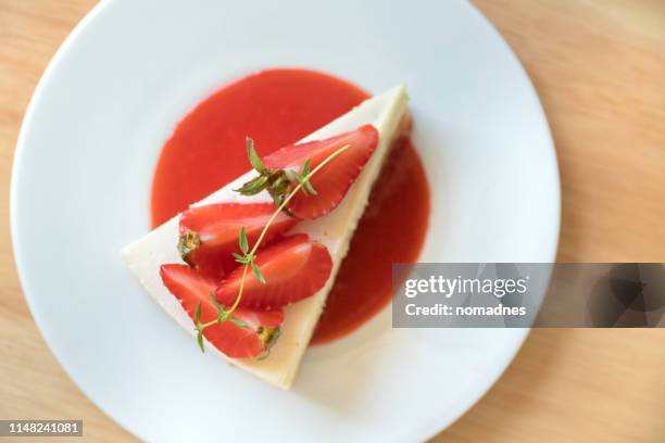 strawberry cheesecake on a white plate. - strawberry syrup stock pictures, royalty-free photos & images