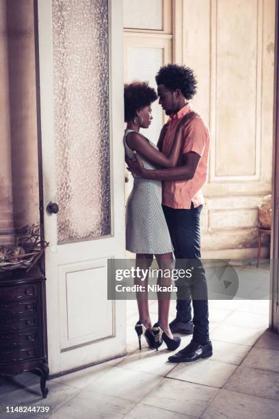 young cuban couple standing at doorway - havana door stock pictures, royalty-free photos & images