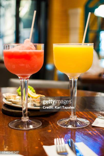 mango and watermelon shake on a dining table - mango juice stockfoto's en -beelden