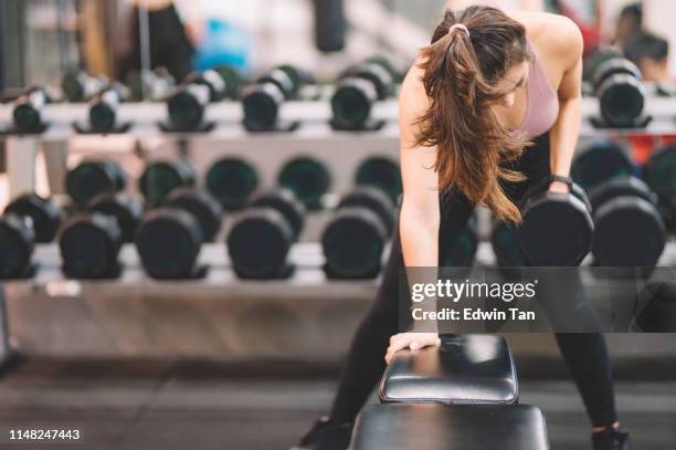 Female Racking Weights Dumbbells On Rack At Gym Photos and Premium High Res Pictures - Getty ...