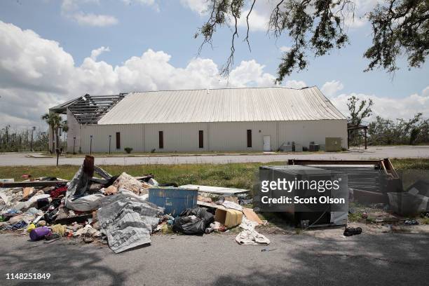 Debris from homes damaged by Hurricane Michael is piled along a road on May 10, 2019 in Panama City, Florida. Seven months after the category five...
