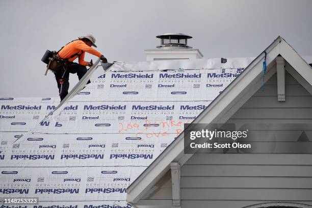 Roofer repairs the roof of a home home damaged by Hurricane Michael on May 10, 2019 in Panama City, Florida. Seven months after the category five...