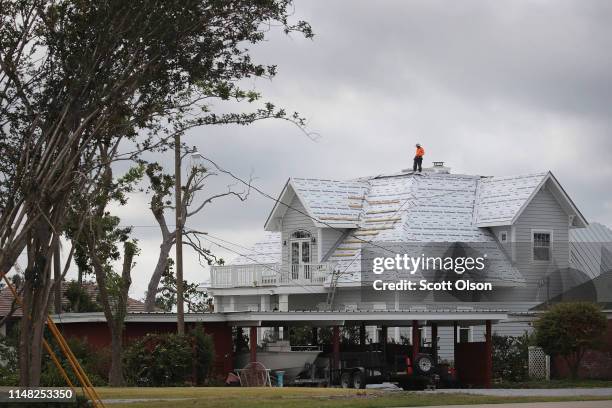 Roofer repairs the roof of a home home damaged by Hurricane Michael on May 10, 2019 in Panama City, Florida. Seven months after the category five...