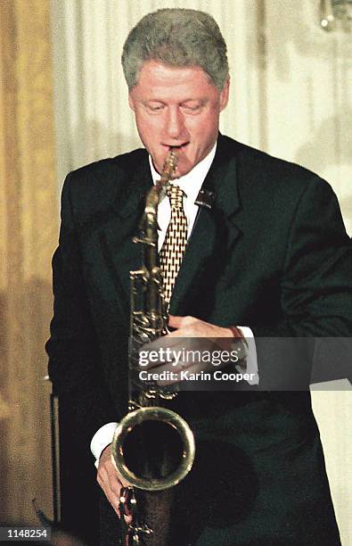 President Bill Clinton plays the saxophone during a birthday celebration July 24, 1998 marking Lionel Hampton's 90th year. Clinton who hasn''t picked...