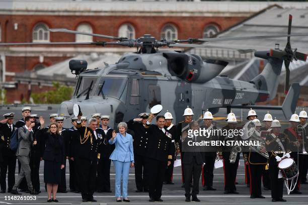 Britain's Prime Minister Theresa May waves beside Britain's Defence Secretary and Minister for Women and Equalities Penny Mordaunt on board the HMS...