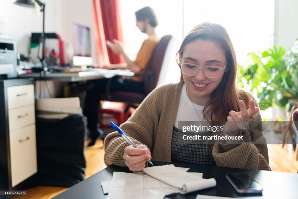 Millennial couple using digital payment to share expense.