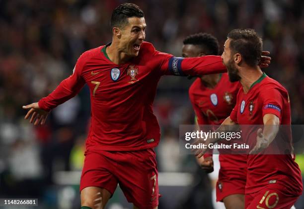 Cristiano Ronaldo of Portugal and Juventus celebrates with teammate Bernardo Silva of Portugal and Manchester City after scoring a goal during the...