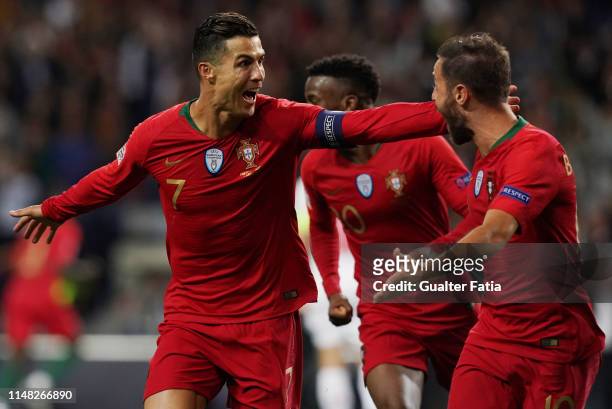 Cristiano Ronaldo of Portugal and Juventus celebrates with teammate Bernardo Silva of Portugal and Manchester City after scoring a goal during the...