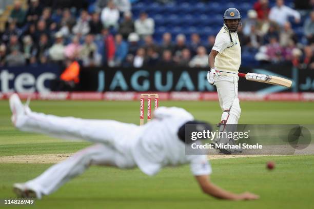 Thilan Samaraweera of Sri Lanka looks back anxiously as Alastair Cook narrowly fails to take the catch off the bowling of Chris Tremlett during day...