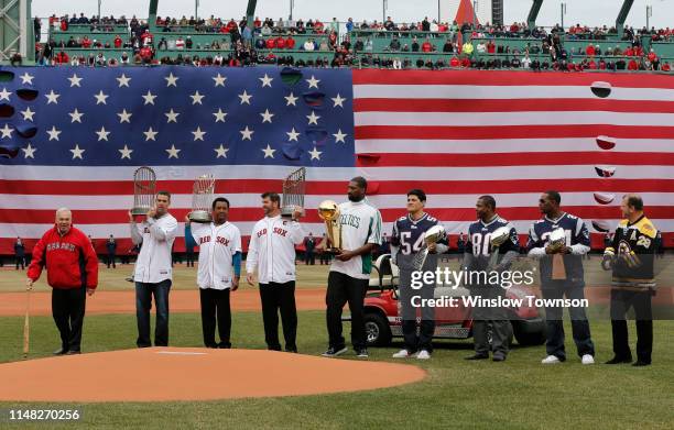 Former Boston Mayor Thomas Menino, left, takes the mound as, left to right, former Boston Red Sox players Mike Lowell, Pedro Martinez and Jason...