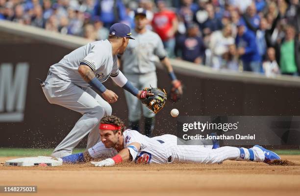 Albert Almora Jr. #5 of the Chicago Cubs slides in to second base with a double ahead of the throw to Hernan Perez of the Milwaukee Brewers in the...
