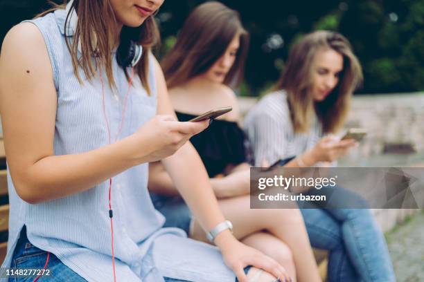 using mobile phone in public park - staring stock pictures, royalty-free photos & images