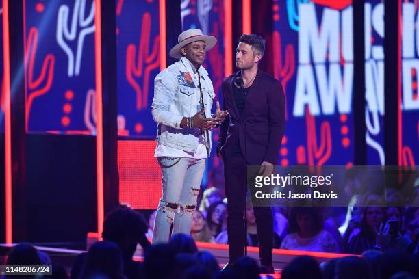 Recording Artists Jimmie Allen and Michael Ray speak on stage during 2019 CMT Music Awards Show at Bridgestone Arena on June 5, 2019 in Nashville,...