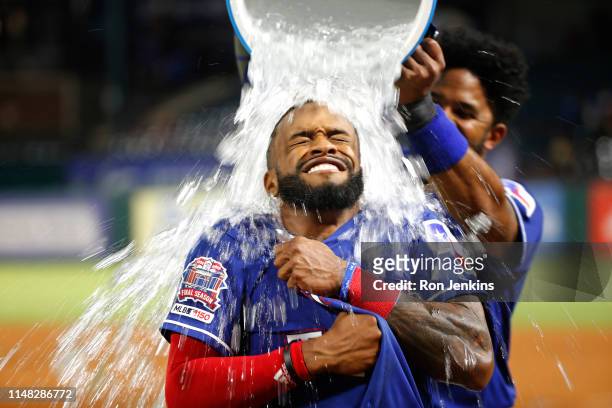 Delino DeShields of the Texas Rangers is doused by teammate Elvis Andrus after DeShields drove in the winning run to defeat the Baltimore Orioles 2-1...
