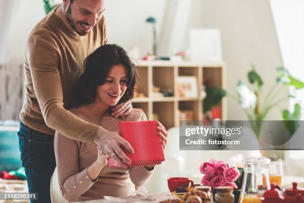 giving her a gift - couple in surprise stock pictures, royalty-free photos & images